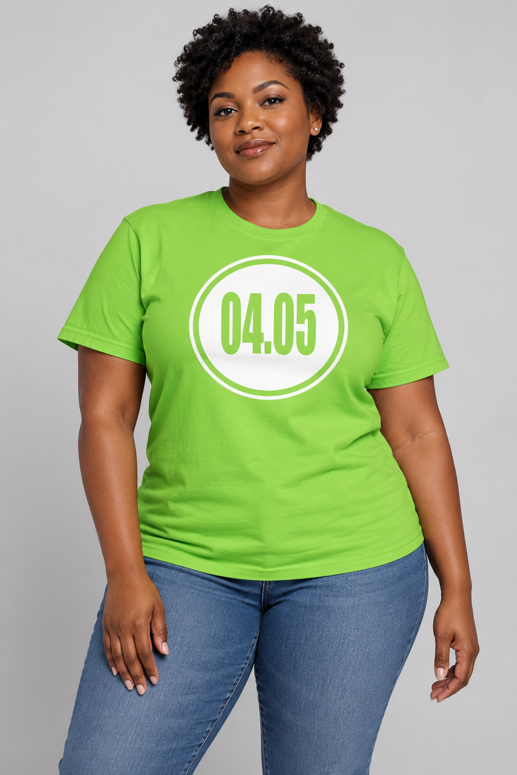 AI-generated Black woman age 34, dark skin, full curvy build, short natural curls wearing Women’s 04.05 Bordered Circle Classic Tee — Lime; clean light gray studio with soft directional light