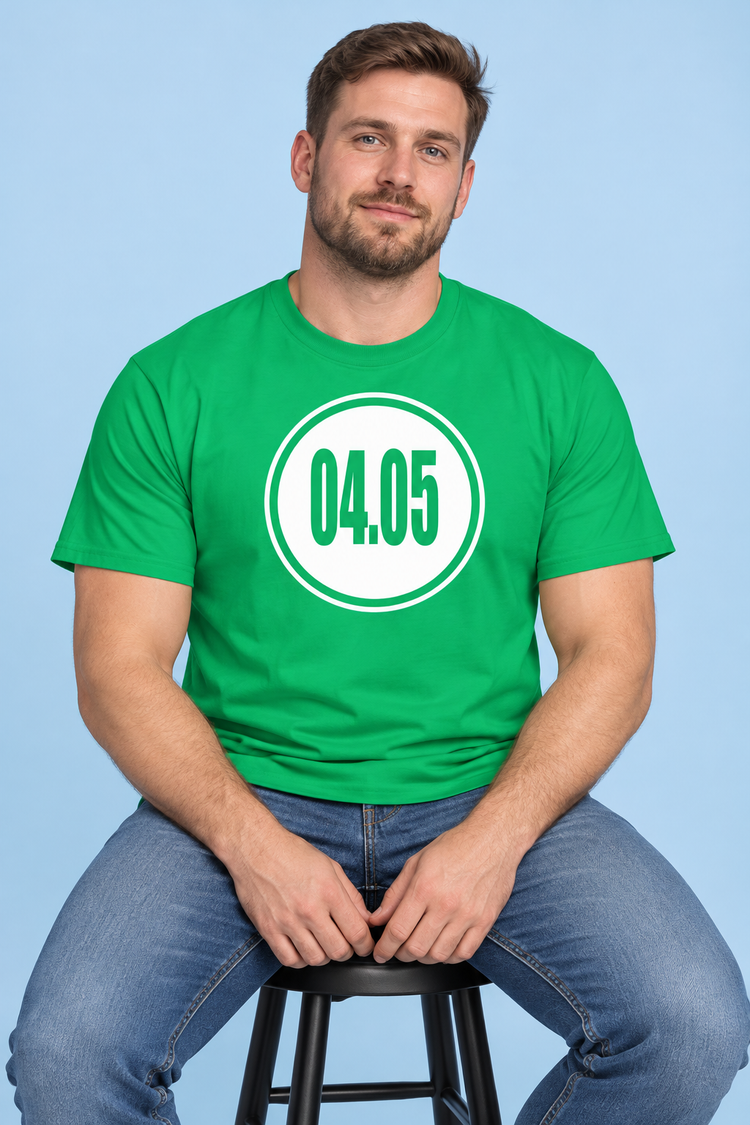 AI-generated White man age 32, fair skin, broad build, short brown hair and light beard wearing Men’s 04.05 Bordered Circle Classic Tee — Irish Green; clean pale blue studio